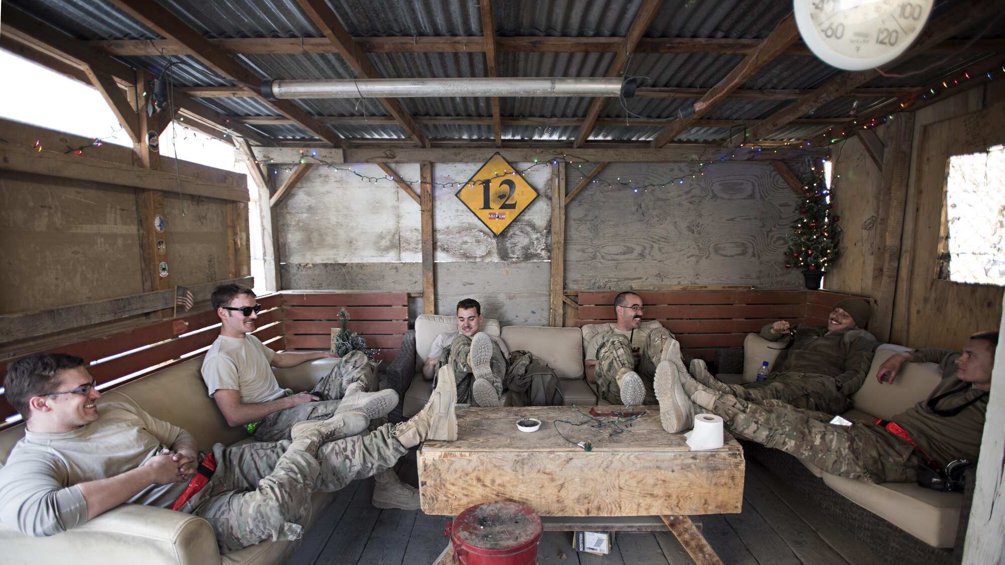 Members of the 455th Expeditionary Aircraft Maintenance Squadron celebrate the completion of their new hang-out spot on Thanksgiving, Nov. 24, 2016 at Bagram Airfield, Afghanistan. Units around Bagram do their best to make the deployed location feel like home by decorating, building places to relax and playing games. (U.S. Air Force photo by Staff Sgt. Katherine Spessa)
