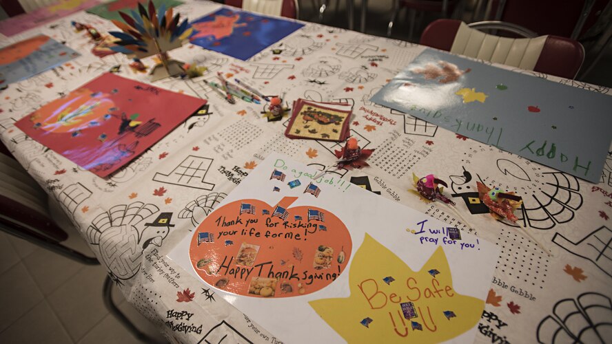 Members of the 455th Expeditionary Medical Group decorated a table for Thanksgiving with placemats sent in care packages Nov. 24, 2016 at Bagram Airfield, Afghanistan. Decorations, cards and gifts are sent in care packages from family, friends and charities across the U.S. and help brighten the holidays for deployed service members. (U.S. Air Force photo by Senior Airman Daniel Lasal)
