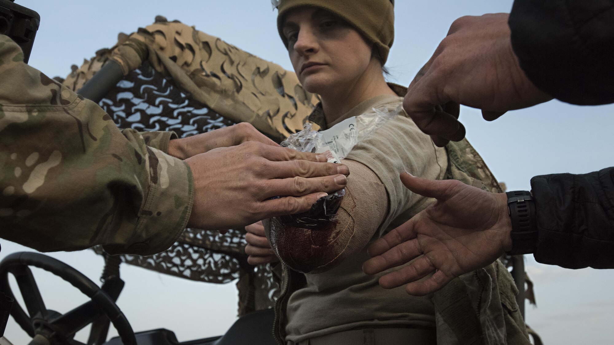 Pararescuemen apply moulage to Senior Airman Kelsey Desz, 83rd Expeditionary Rescue Squadron aviation resource manager, before a mass casualty exercise held Nov. 17, 2016 at Bagram Airfield, Afghanistan. Moulage is makeup used to create lifelike injuries to provide realistic training. (U.S. Air Force photo by Staff Sgt. Katherine Spessa)