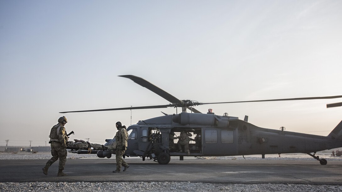 Senior Airman Tammer Barkouki, 83rd Expeditionary Rescue Squadron pararescuman, and Maj. David Depiazza, 83rd ERQS combat rescue officer, carry a patient by litter onto an HH-60 Pave Hawk helicopter for evacuation during a mass casualty exercise held Nov. 17, 2016 at Bagram Airfield, Afghanistan. Training scenarios are based on real-world situations that have been encountered in past operations. (U.S. Air Force photo by Staff Sgt. Katherine Spessa)
