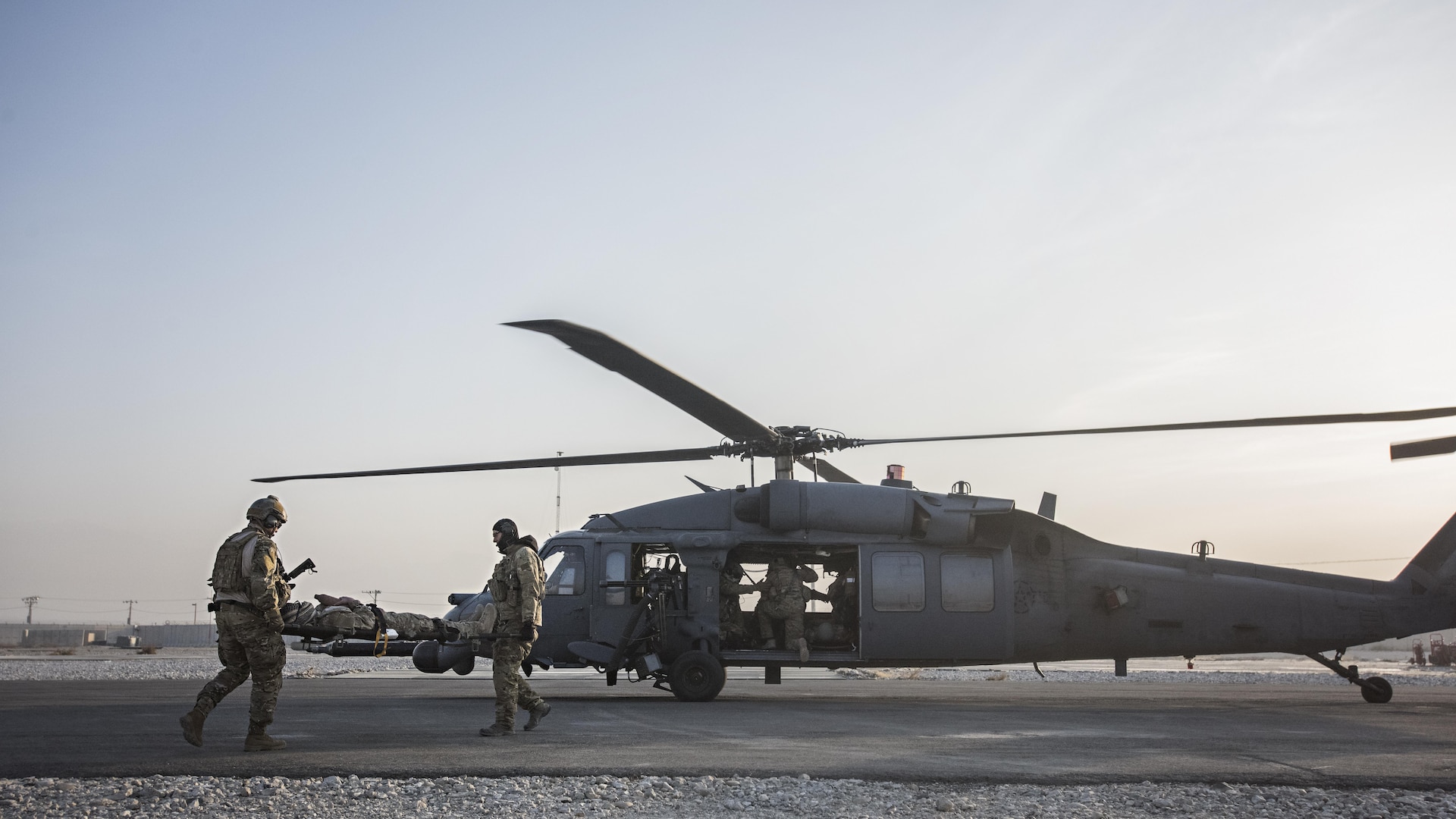 Senior Airman Tammer Barkouki, 83rd Expeditionary Rescue Squadron pararescuman, and Maj. David Depiazza, 83rd ERQS combat rescue officer, carry a patient by litter onto an HH-60 Pave Hawk helicopter for evacuation during a mass casualty exercise held Nov. 17, 2016 at Bagram Airfield, Afghanistan. Training scenarios are based on real-world situations that have been encountered in past operations. (U.S. Air Force photo by Staff Sgt. Katherine Spessa)