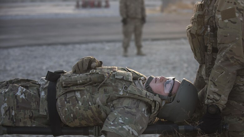 Tech. Sgt. Amity Quinones, 83rd Expeditionary Rescue Squadron intelligence specialist, acts as an injured servicemember during a mass casualty exercise held Nov. 17, 2016 at Bagram Airfield, Afghanistan. The exercise provided realistic training on how to respond to an IED blast resulting in multiple injuries. (U.S. Air Force photo by Staff Sgt. Katherine Spessa)