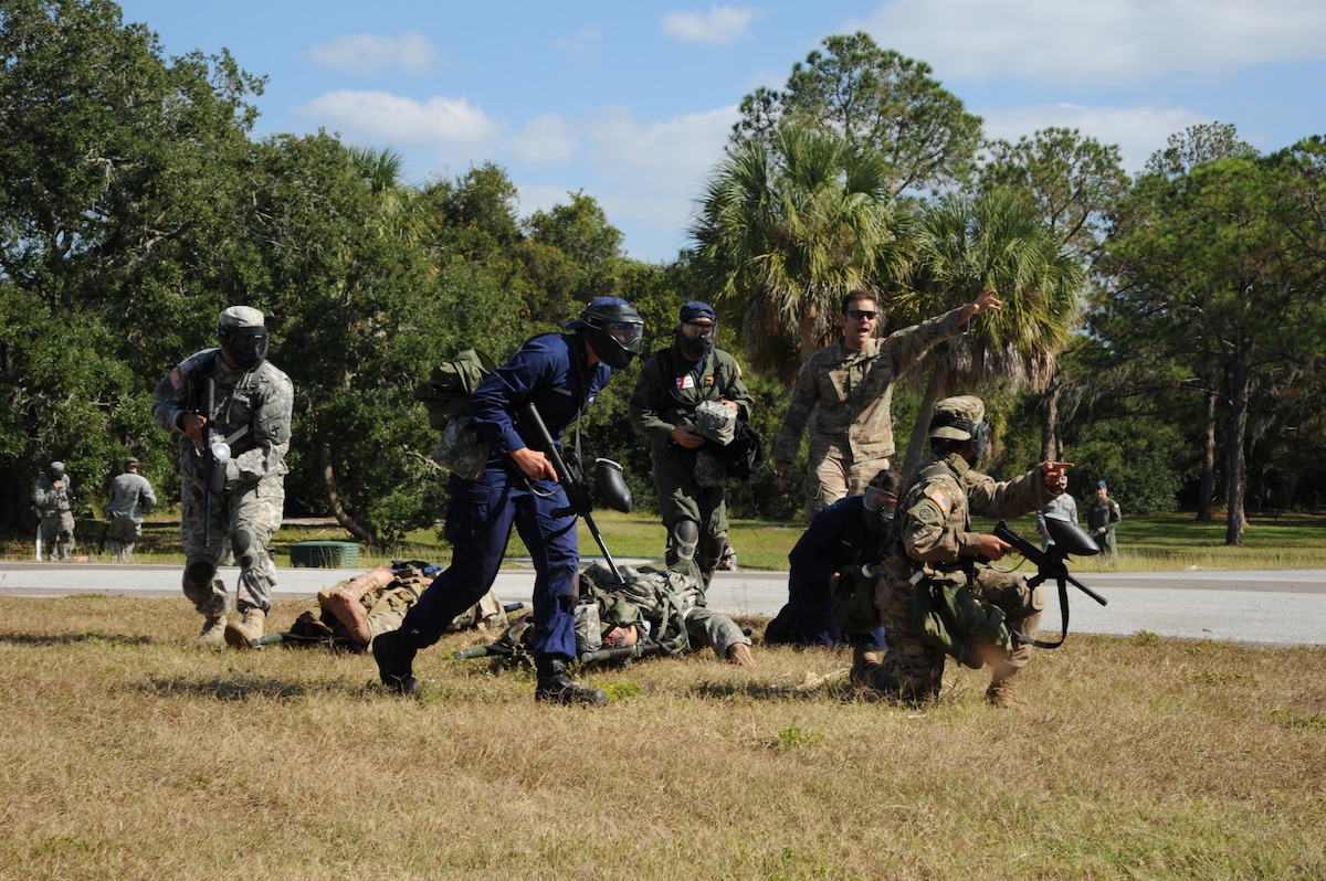 Certified TCCC instructors from the Air Force Reserve 927th Air Refueling Wing, MacDill Air Force Base, Florida and active duty 6 Air Mobility Wing, MacDill AFB, facilitated a three-day joint TCCC course here, 16 through 18 Nov. The three part course, included textbook, hands-on medical training and on the final day, an as realistic as possible scenario that is designed for the trainee to react under pressure. The final scenario staged life-like mannequins posing as a patrol that encountered an improvised explosive device. Trainees had to perform all aspects of TCCC while actively under hostile fire, paintballs. (U.S. Air Force Photo/Tech. Sgt. Peter Dean)