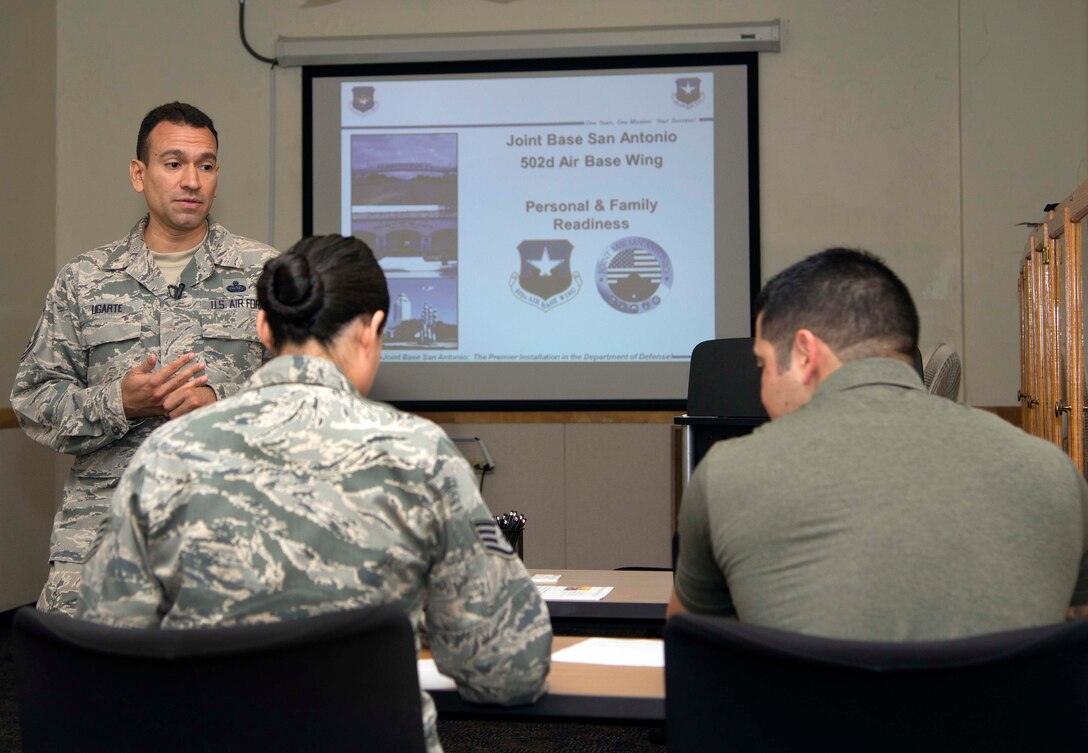 Air Force Master Sgt. Joe Ugarte, 802nd Force Support Squadron Military Family Readiness Center readiness noncommissioned officer, briefs service members and their families who are readying themselves for an upcoming deployment at Joint Base San Antonio-Randolph, Texas, May 24, 2016. Courtesy photo