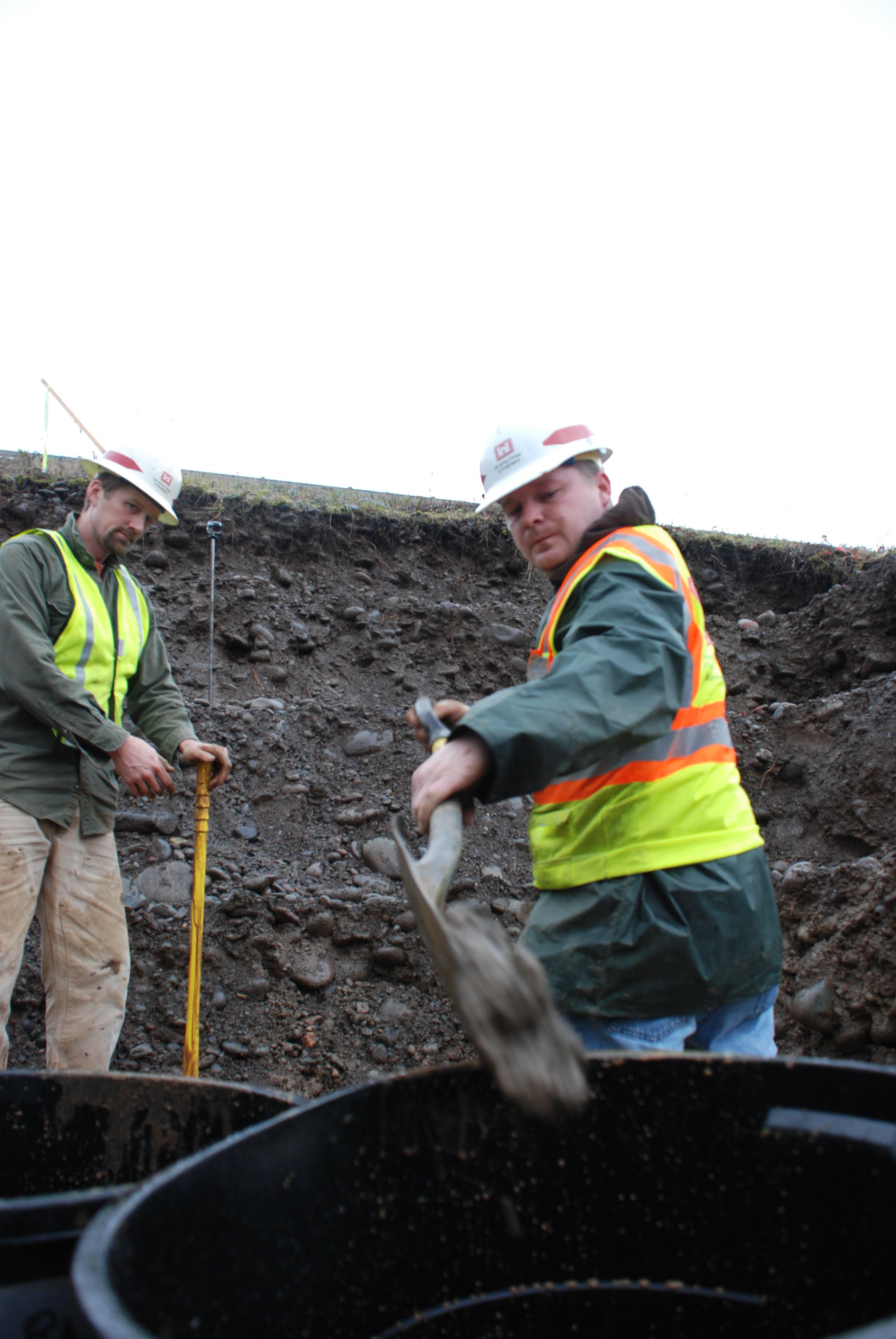 Corps Employees dig test pit