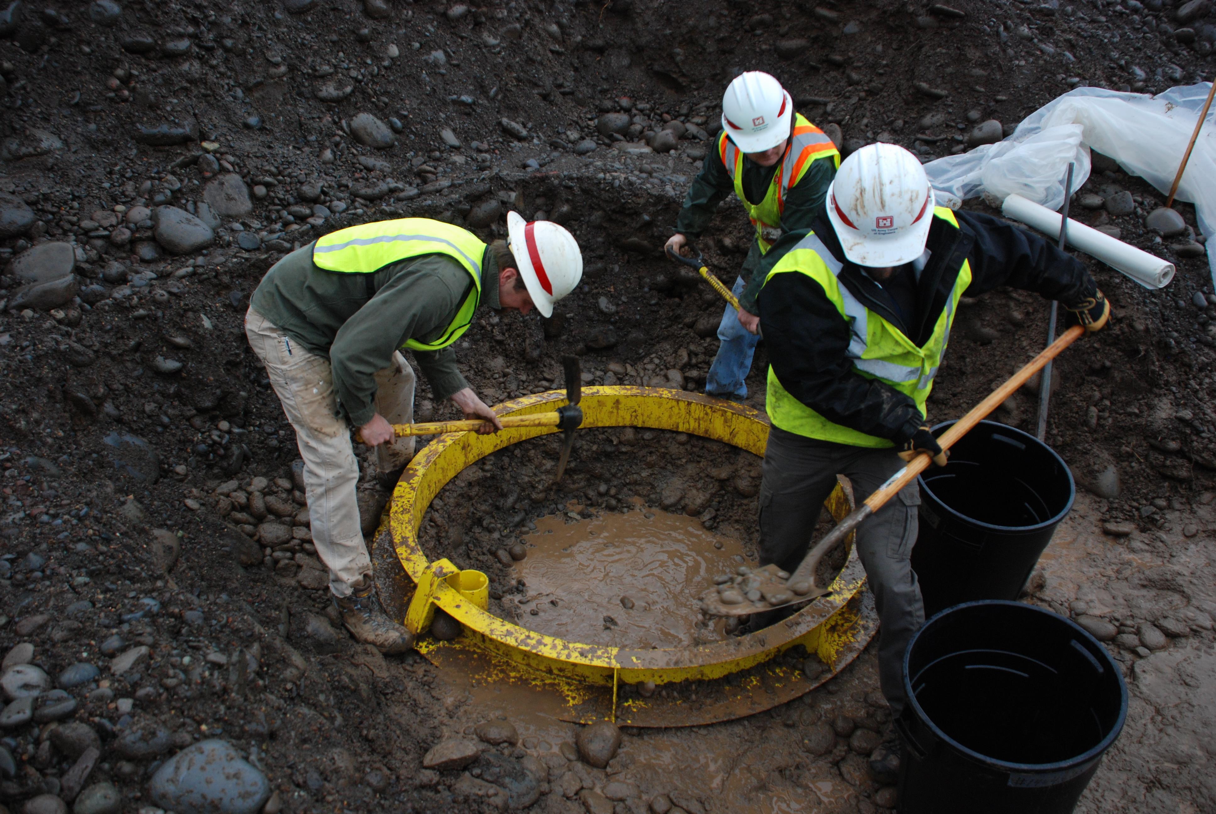 Corps Employees dig test pit