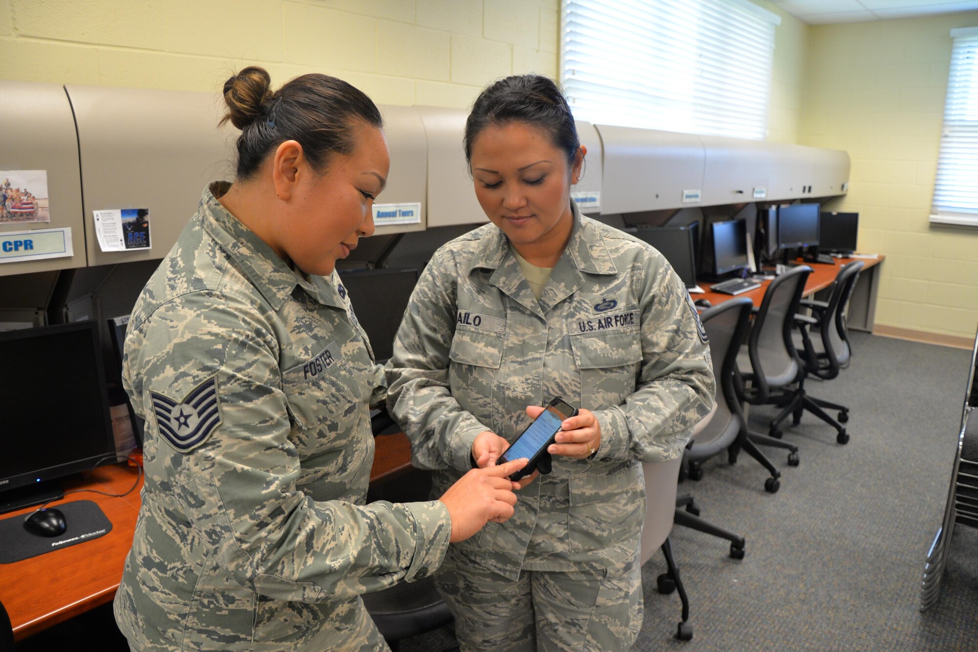 Air Force Master Sgt. Maria Tailo, right, shows Tech. Sgt. Yommala Foster the Get 1Now phone app, which provides an opportunity for Reservists to recommend qualified people with whom they wish to serve alongside. Located on Oahu and Guam, and a component of the Air Force Reserve, the 624th Regional Support Group's mission is to deliver mission essential capability through combat readiness, quality management and peacetime deployments in the Pacific area of responsibility. (U.S. Air Force photo by Master Sgt. Theanne Herrmann)