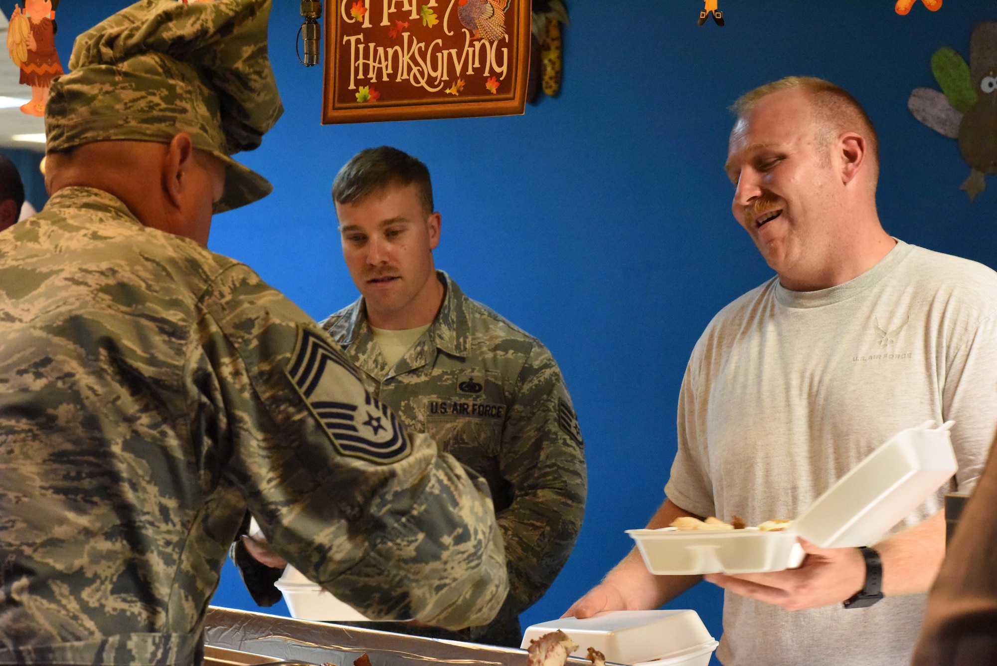 Senior leaders with the 379th Air Expeditionary Wing team up with the 379th Expeditionary Force Support Squadron dining facility team to serve Thanksgiving lunch and dinner at Al Udeid Air Base, Qatar, Nov. 24, 2016. In celebration of the holiday, the dining facility prepared a special feast for lunch and dinner that included many traditional Thanksgiving dishes. (U.S. Air Force photo by Senior Airman Cynthia A. Innocenti)