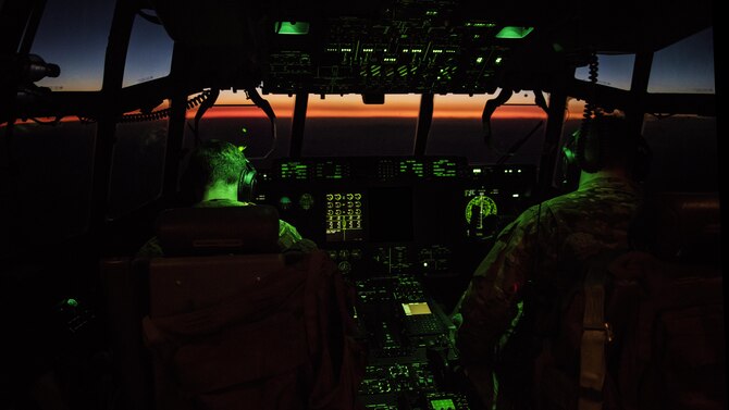 Capts. Nick Bonner and David Tart, 774th Expeditionary Airlift Squadron C-130J Hercules pilots, fly a C-130 to Farah Airfield, Afghanistan Nov. 10, 2016. The 774th EAS uses the unique versatility of the C-130 to supplement tactical airlift capabilities for units in and out of austere locations under atypical conditions. Edits were made to this image for security purposes. (U.S. Air Force illustration by Staff Sgt. Katherine Spessa)