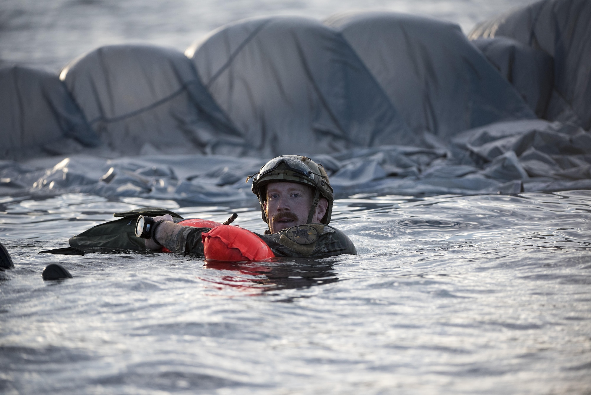 A U.S. Air Force Airman from the 320th Special Tactics Squadron waits for a pick up after performing a long-range jump from a C-17 Globemaster III into the Pacific Ocean Nov. 22, 2016. The 320th STS Airmen are capable of establishing drop zones, air traffic control, combat medical care and evacuation, and combat search and rescue. (U.S. Air Force photo by Senior Airman Omari Bernard/Released)