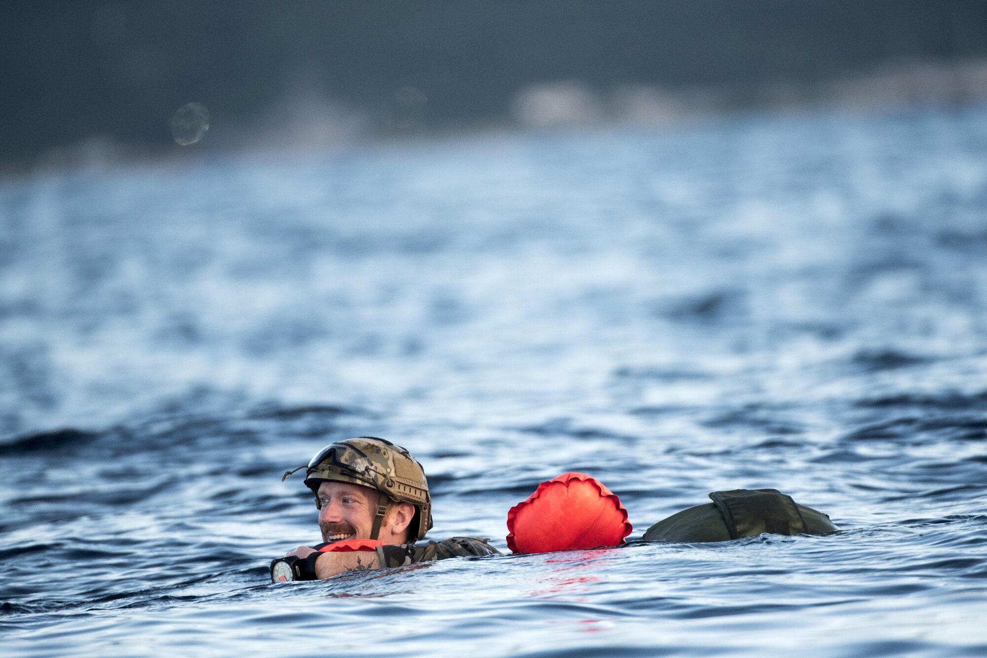 A U.S. Air Force Airman from the 320th Special Tactics Squadron swims to a vessel after performing a long-range jump from a C-17 Globemaster III into the Pacific Ocean Nov. 22, 2016. The 320th STS has combat controllers, pararescuemen and special operations weather teams who go anywhere and set up forward operating locations and impromptu runways. (U.S. Air Force photo by Senior Airman Omari Bernard/Released)