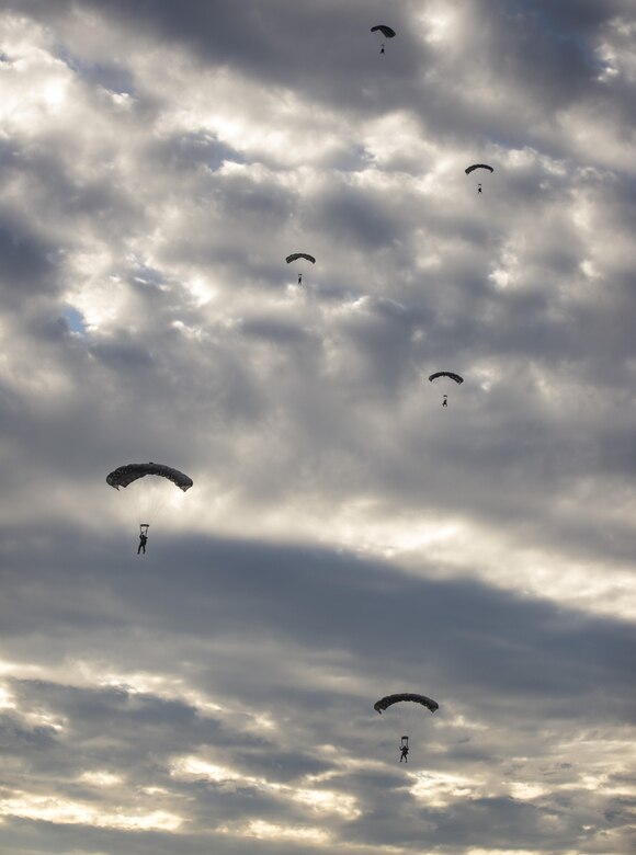 U.S. Air Force Airmen from the 320th Special Tactics Squadron parachute from a C-17 Globemaster III during a long-range training jump Nov. 22, 2016, into the Pacific Ocean. Teamwork and coordination is vital to the success and safe completion of special tactics objectives. (U.S. Air Force photo by Senior Airman Omari Bernard/Released)