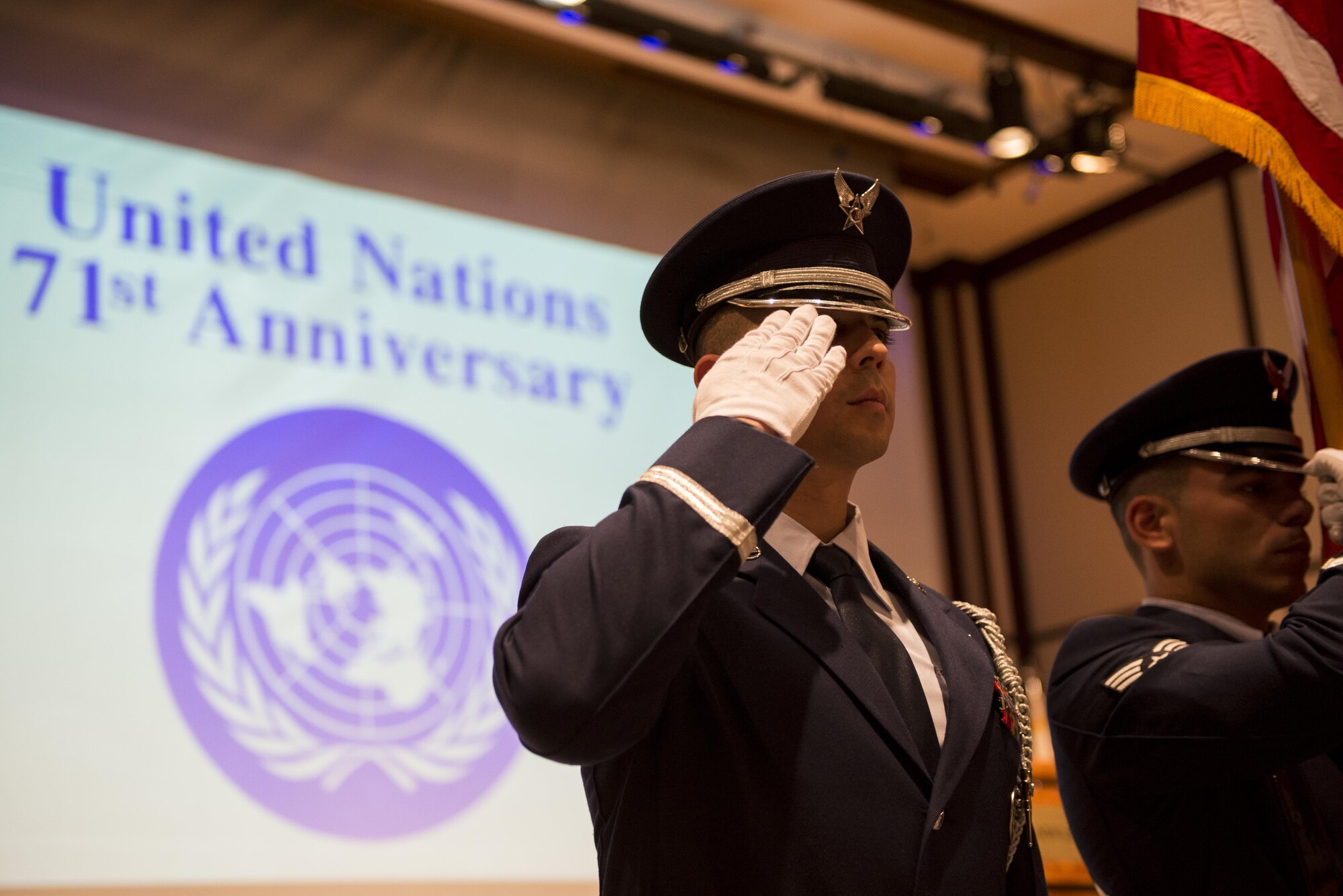 A Yokota Air Base Honor Guard member salutes during the presentation of the colors ceremony during the United Nations Day 71st Anniversary Celebration in Tokyo, Japan, Nov. 21, 2016. United Nations Day commemorates the anniversary of the United Nations Charter in 1945 and has been celebrated as U.N. Day since 1948. (U.S. Air Force photo by Airman 1st Class Donald Hudson/Released)