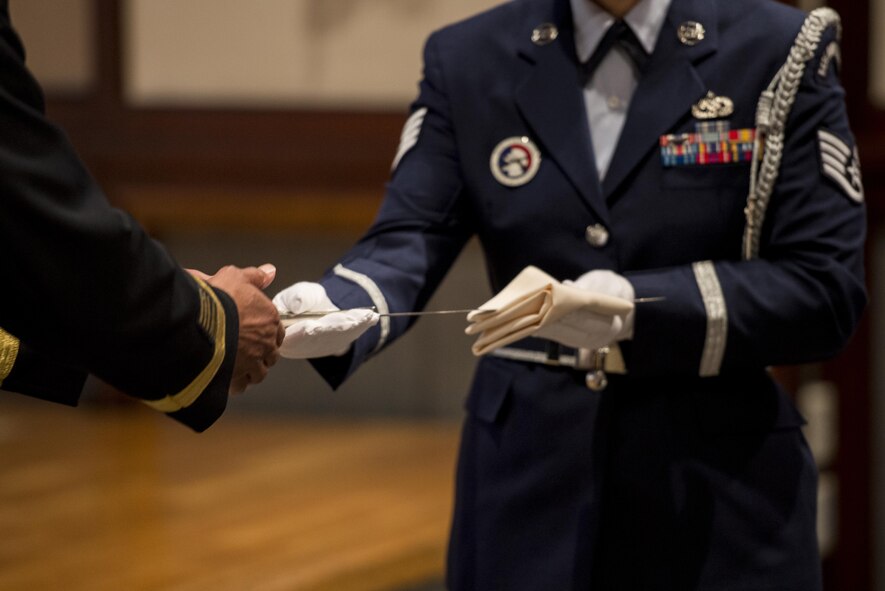 A member of the Yokota Air Base Honor Guard presents a knife to U.S. Army Gen. Vincent K. Brooks, United Nations Command commander, for cake cutting during the United Nations Day 71st Anniversary Celebration in Tokyo, Japan, Nov. 21, 2016. The event was staged by the United Nations Command-Rear, which has been located at Yokota since 2007. (U.S. Air Force photo by Airman 1st Class Donald Hudson/Released)