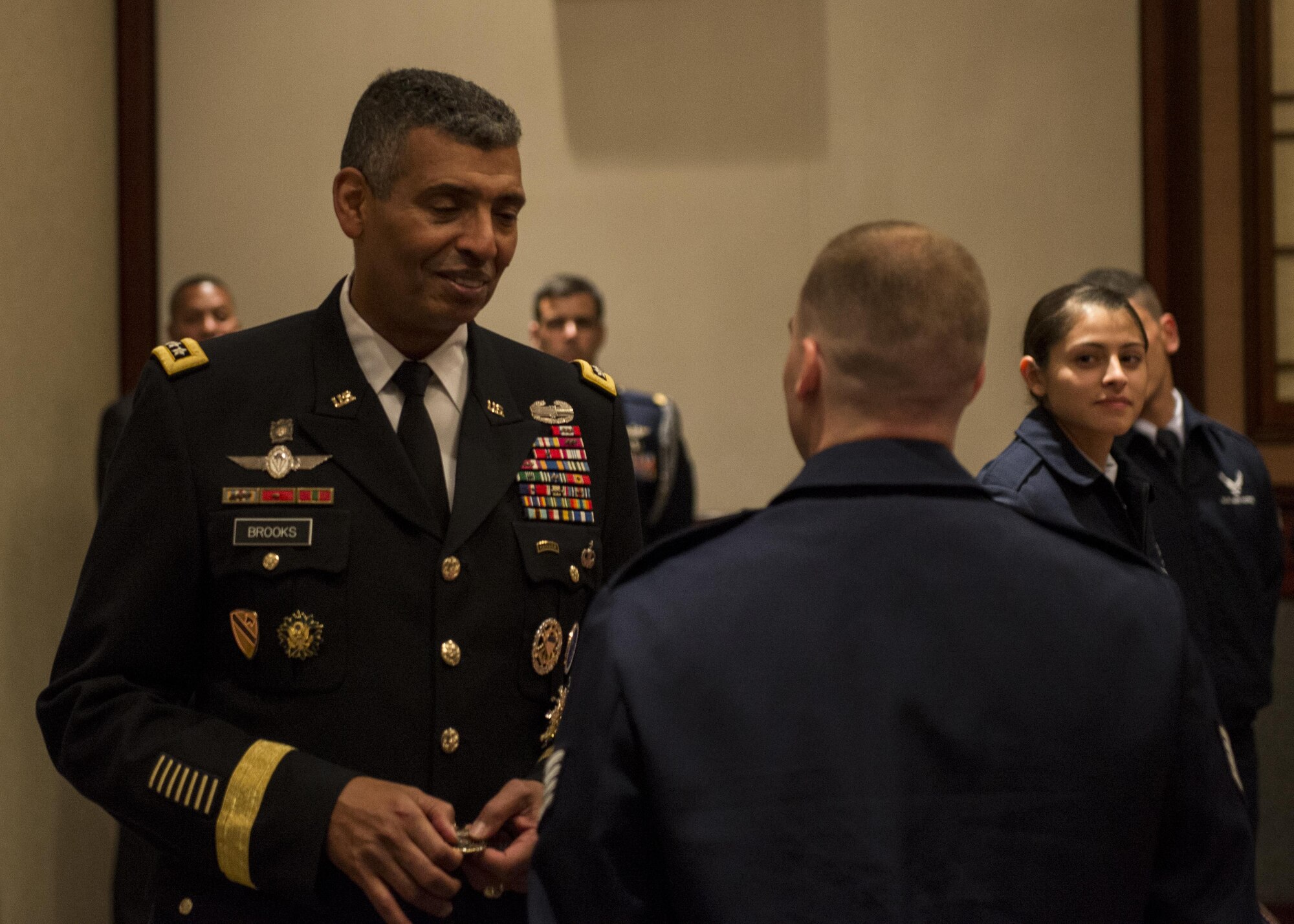 U.S. Army Gen. Vincent K. Brooks, United Nations Command commander, presents command coins to the members of the Yokota Air Base Honor Guard for their performance during the United Nations Day 71st Anniversary Celebration in Tokyo, Japan, Nov. 21, 2016. United Nations Day commemorates the anniversary of the United Nations Charter in 1945 and has been celebrated as U.N. Day since 1948. (U.S. Air Force photo by Airman 1st Class Donald Hudson/Released)
