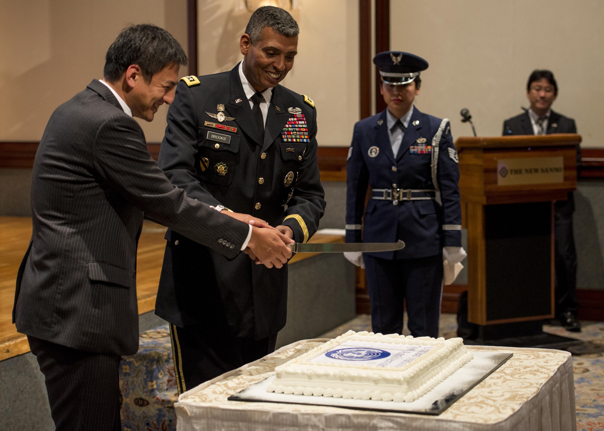U.S. Army Gen. Vincent K. Brooks, United Nations Command commander, right, and Shunsuke Takei,  Parliamentary Vice-Minister  for Foreign Affairs, left, cut a cake during the United Nations Day 71st Anniversary Celebration in Tokyo, Japan, Nov. 21, 2016. The event was staged by the United Nations Command-Rear, which has been located at Yokota since 2007. (U.S. Air Force photo by Airman 1st Class Donald Hudson/Released)