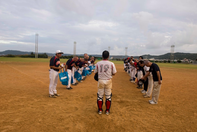 Members of the U.S. Consulate Allstars and Okinawa Prefectural Government Baseball Teams bow to each other after a baseball game Nov. 19, 2016, at a baseball field in Naha, Japan. The Allstars play games against teams on Okinawa to make friends and foster partnerships in the local community. (U.S. Air Force photo by Senior Airman Omari Bernard/Released)xxx