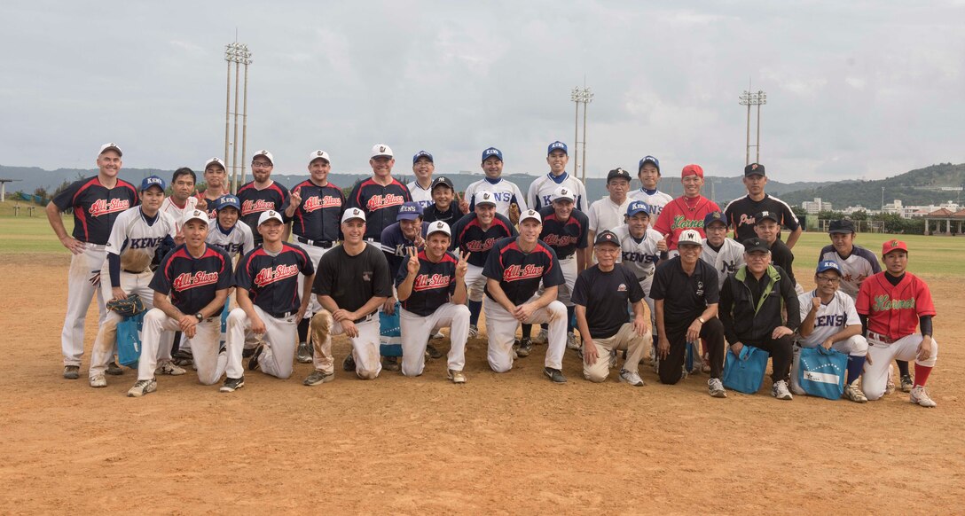 The U.S. Consulate Allstars and Okinawan Prefectural Government competitors take a group photo commemorating their game together Nov. 19, 2016 at a baseball field in Naha, Japan. The Allstars are scheduled to continue playing more baseball games throughout the rest of the year and into the summer of 2017 spreading diplomacy and building partnerships through baseball. (U.S. Air Force photo by Senior Airman Omari Bernard/Released)