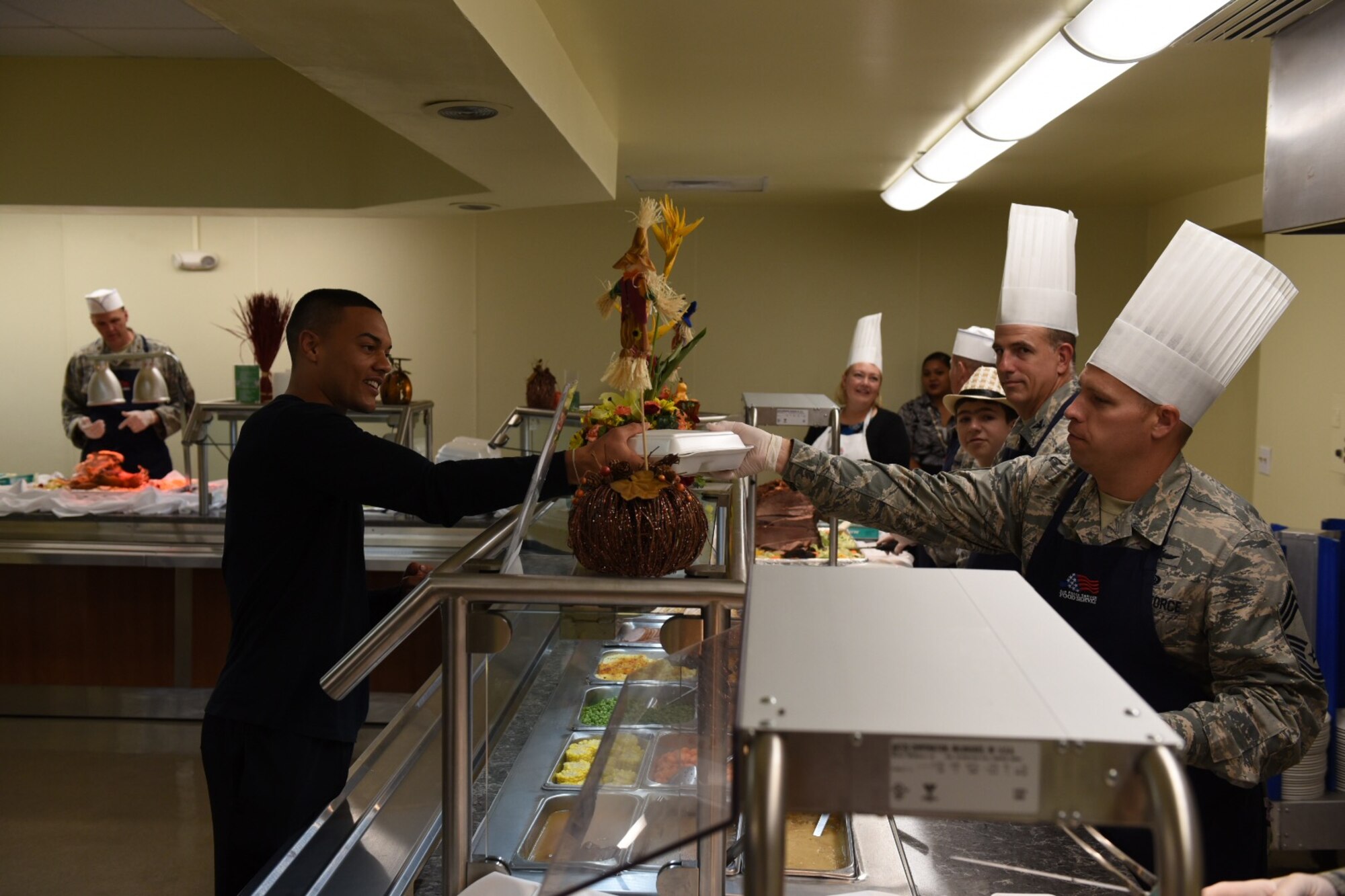 U.S. Air Force 36th Wing leadership serve Airmen Thanksgiving meals at the Magellan Inn dining facility Nov. 24, 2016, at Andersen Air Force Base, Guam. The annual event, held in the dining facility, brings service members together to eat and have a traditional Thanksgiving meal away from home with friends and family. (U.S. Air Force photo by Airman 1st Class Jacob Skovo)