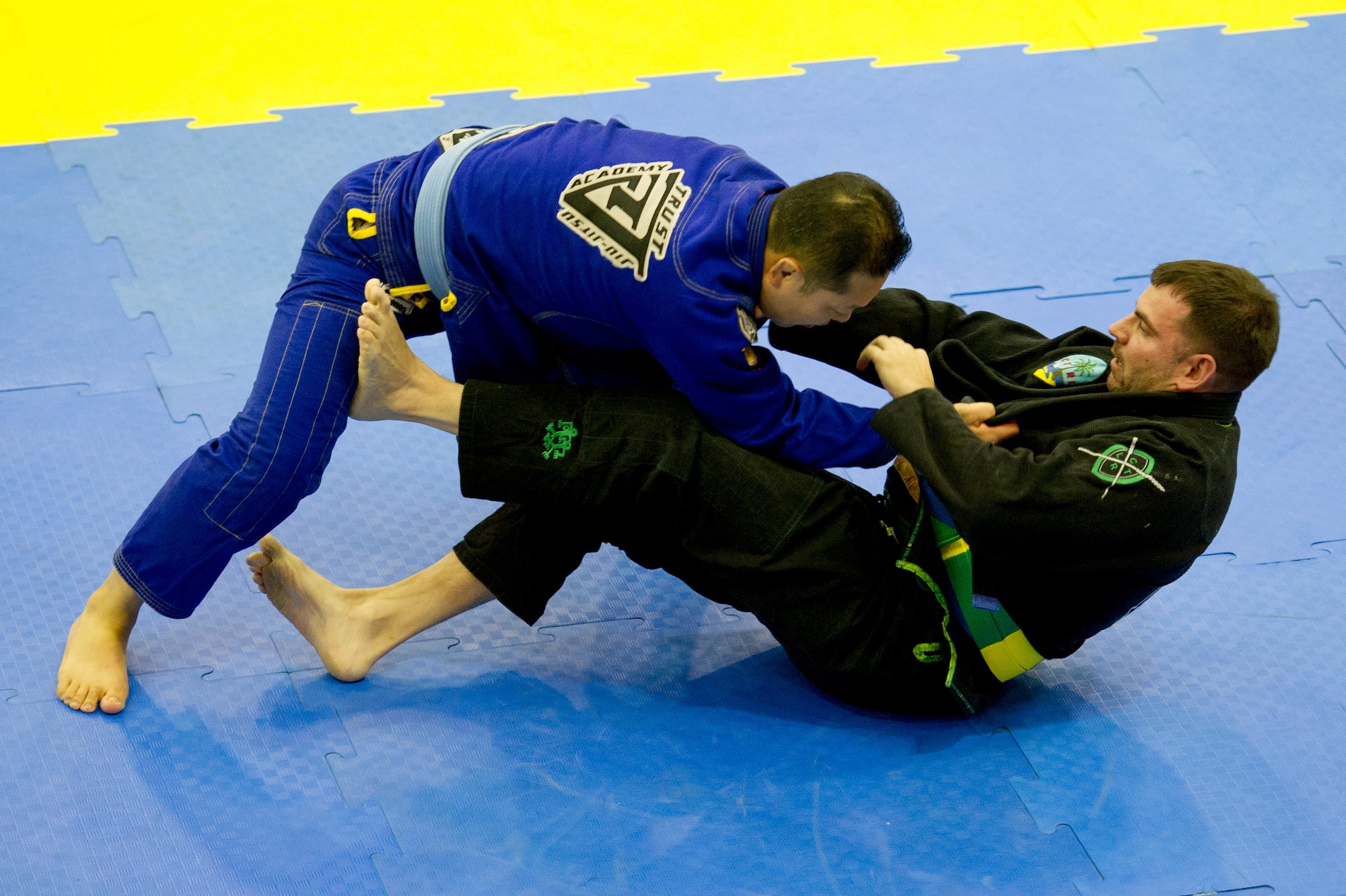 U.S. Air Force Master Sgt. Thomas Matzke, right, 607th Air Support Operations Group tactical air control party, defends against Kim San during a senior open weight class blue belt Jiu-Jitsu match during the Dumau Jiu-Jitsu Korea Grand Prix 2016 in Seoul, Republic of Korea, Nov. 27, 2016. Matzke was one of four Airmen from Osan to compete in the jiu-jitsu tournament. (U.S. Air Force photo by Staff Sgt. Jonathan Steffen)