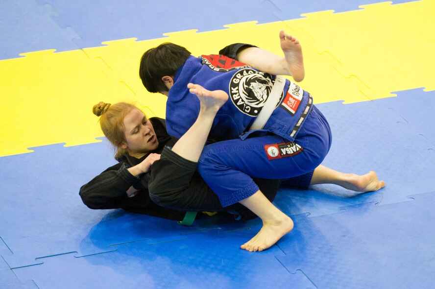 U.S. Air Force Senior Airman Kate West, 51st Medical Operations Squadron medical technician, pulls guard against Eunju Shin during a feather-weight white belt Jiu-Jitsu match during the Dumau Jiu-Jitsu Korea Grand Prix 2016 in Seoul, Republic of Korea, Nov. 27, 2016. This was West’s first tournament after training for the last ten months at Osan. (U.S. Air Force photo by Staff Sgt. Jonathan Steffen)