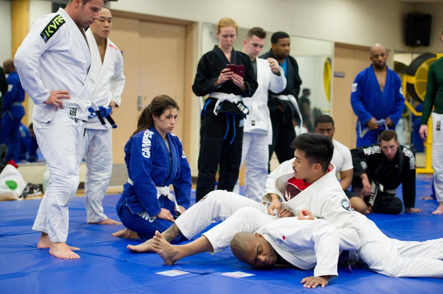 U.S. Air Force Staff Sgt. Christopher Costa, top, 51st Communications Squadron radio frequencies transmissions systems supervisor, demonstrates a submission move on Staff Sgt. Devin Fields, 607th Support Squadron NCO in charge Kunsan element, during a Brazilian jiu-jitsu class at Osan Air Base, Republic of Korea, Nov. 21, 2016. Costa prepared and trained Airmen that participated in the Dumau Jiu-Jitsu Korea Grand Prix 2016 in Seoul on Nov. 27, 2016. (U.S. Air Force photo by Staff Sgt. Jonathan Steffen)
