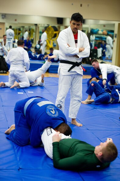 U.S. Air Force Staff Sgt. Christopher Costa, 51st Communications Squadron radio frequencies transmissions systems supervisor, observes his students practicing Brazilian jiu-jitsu at Osan Air Base, Republic of Korea, Nov. 21, 2016. Costa teaches jiu-jitsu to team Osan members on-base during his off-duty hours. (U.S. Air Force photo by Staff Sgt. Jonathan Steffen)