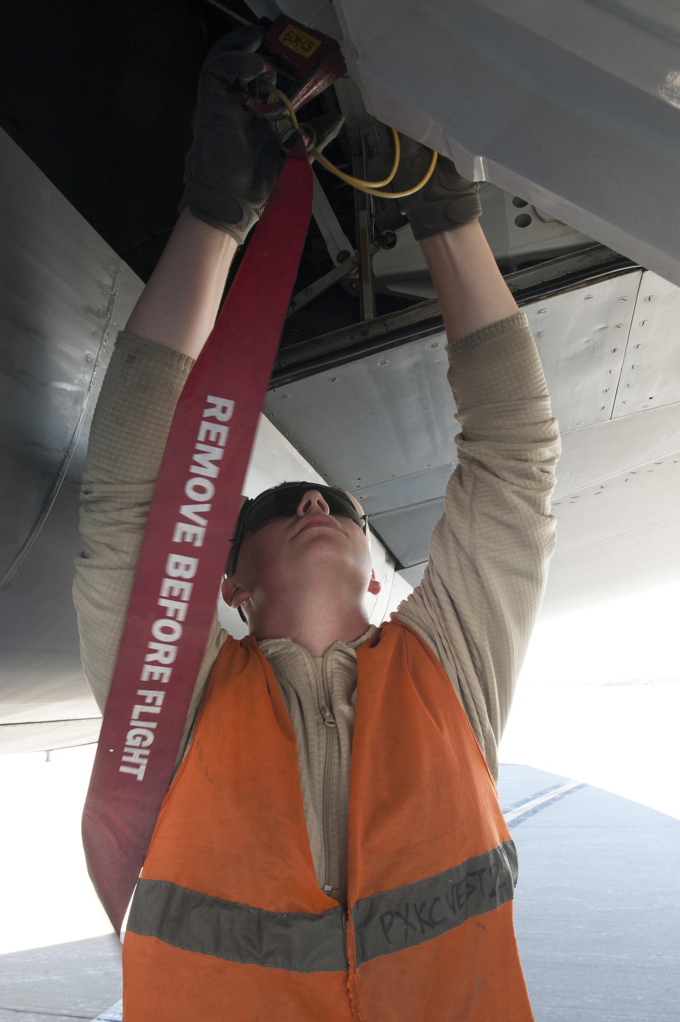 U.S. Air Force Airman 1st Class Nathaniel, 447th Expeditionary Aircraft Maintenance Squadron crew chief, places safety pins in place on a KC-135 Stratotanker Nov. 2, 2016, at Incirlik Air Base, Turkey. Safety pins are used to lock points of the aircraft in place while on ground for safety. (U.S. Air Force photo by Staff Sgt. Jack Sanders)