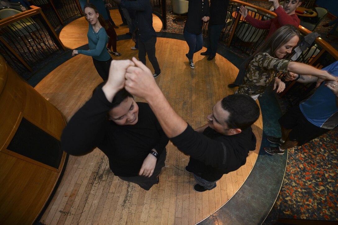 Participants from the Lively Latin Dance Class practice their moves Nov. 18, 2016, on RAF Mildenhall, England. The event, hosted by the Center for Character and Culture, provided members of Team Mildenhall an opportunity to meet new people, develop new friendships, be active, relieve stress and work together. (U.S. Air Force photo by Staff Sgt. Micaiah Anthony)