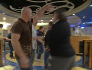 Participants from the Lively Latin Dance Class practice their moves Nov. 18, 2016, on RAF Mildenhall, England. The event, hosted by the Center for Character and Culture, provided members of Team Mildenhall an alternate activity that promotes positive interpersonal communication and stress reduction. (U.S. Air Force photo by Staff Sgt. Micaiah Anthony)