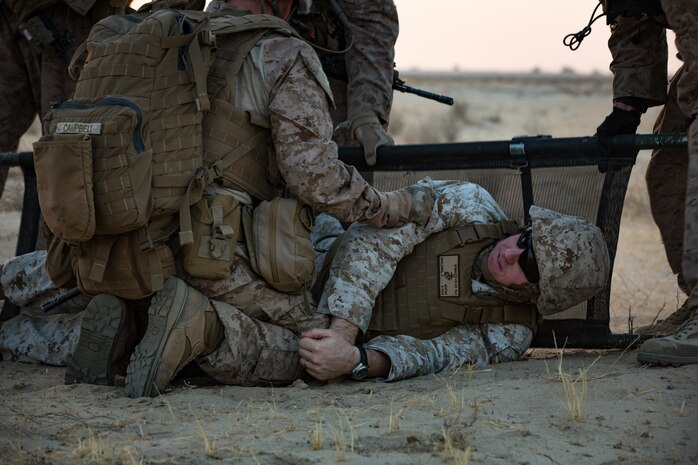 U.S. Marines with 3rd Battalion, 7th Marine Regiment, Special Purpose Marine Air-Ground Task Force - Crisis Response - Central Command, place a simulated casualty on a stretcher while conducting a Tactical Recovery of Aircraft and Personnel exercise, Oct. 8, 2016. SPMAGTF – CR – CC is a self-sustaining expeditionary unit, designed to provide a broad range of crisis response capabilities throughout the Central Command area of responsibility, using organic aviation, logistical, and ground combat assets, to include TRAP and embassy reinforcement. (U.S. Marine Corps photo by Cpl. Trever Statz)