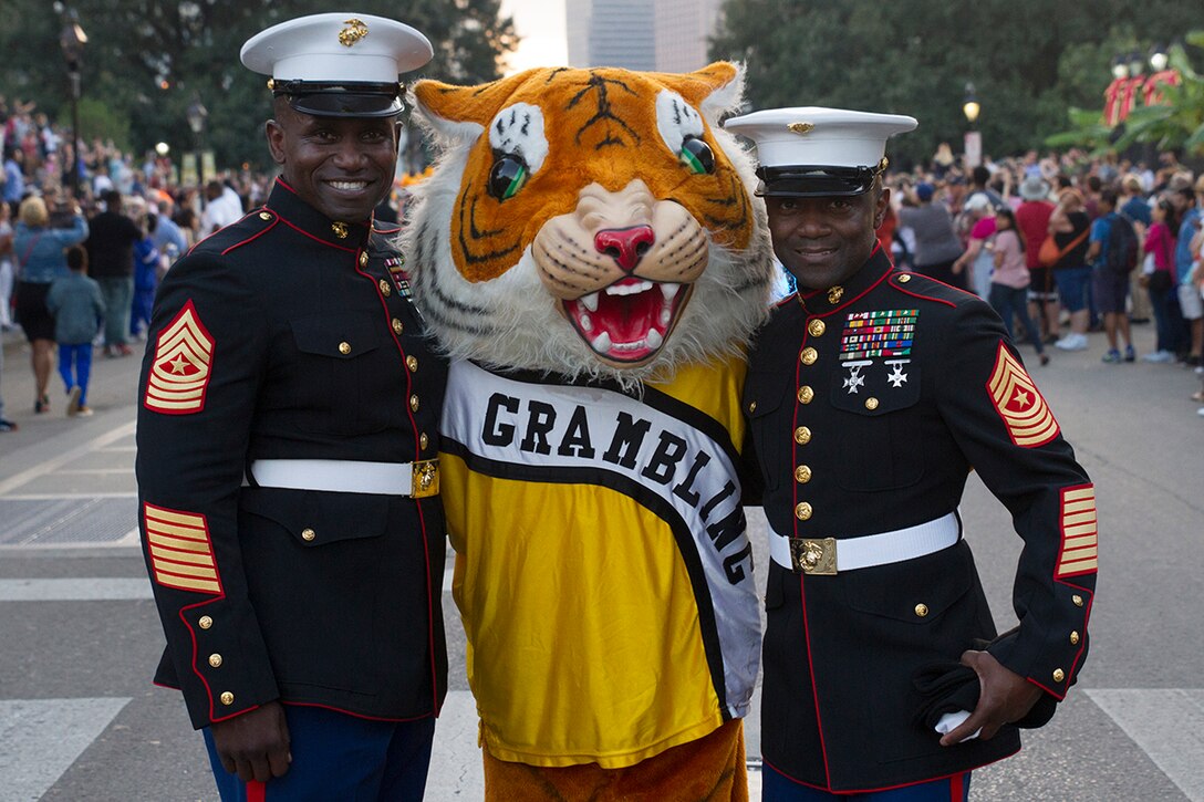 Sergeant Major Anthony N. Page, sergeant major of the 6th Marine Corps District, and Sgt. Maj. Samuel Heyward Jr., sergeant major of the Marine Corps Recruiting Command, pose in a photo with the Grambling State University mascot during the Bayou Classic Thanksgiving Parade Nov. 24, 2016. The Bayou Classic is the annual series of fan events and leading up to the rivalry football game between Southern University and Grambling State University held the week of Thanksgiving.