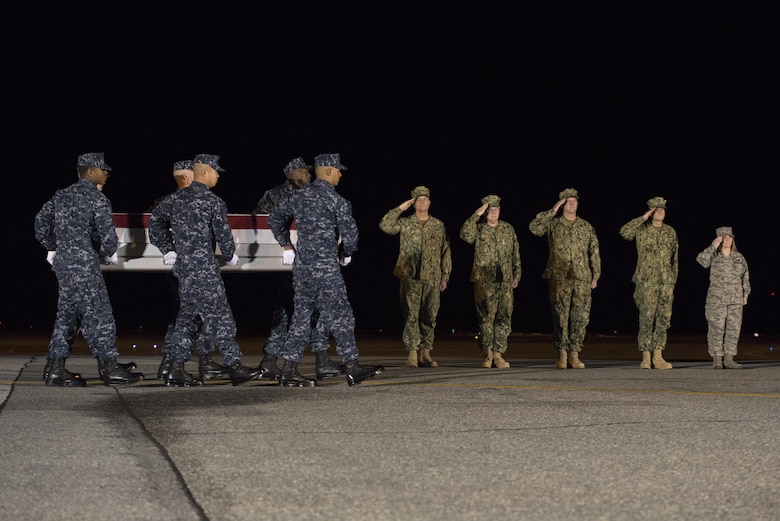 A U.S. Navy carry team transfers the remains of Navy Senior Chief Petty Officer Scott C. Dayton, of Woodbridge, Va., Nov. 27, 2016, during a dignified transfer at Dover Air Force Base, Del. Dayton was assigned to Explosive Ordnance Disposal Mobile Unit Two, which is based in Virginia Beach, Va. (U.S. Air Force photo by Senior Airman Aaron J. Jenne)