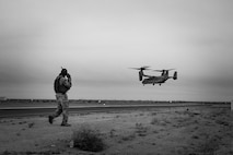 U.S. Marine Corps Staff Sgt. Steven Habon, a platoon sergeant with Fox Company, 2nd Battalion, 7th Marine Regiment, Special Purpose Marine Air Ground Task Force - Crisis Response - Central Command, speaks with MV-22B Osprey crew chiefs over a radio during fast rope training while forward deployed, Sept. 17, 2016. Fast roping enables the quick insert of Marines into hostile landing zones limiting aircraft and personnel vulnerability. SPMAGTF-CR-CC is a self-sustaining expeditionary unit, designed to provide a broad range of crisis response capabilities throughout the Central Command area of responsibility, using organic aviation, logistical and ground combat assets, to include embassy reinforcement  and tactical recovery of aircraft and personnel. (U.S. Marine Corps photo by Cpl. Trever Statz/Released)