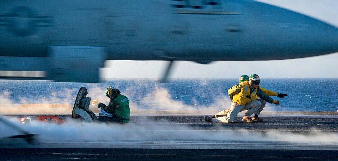 Catapult and arresting gear officers clear the pilot of a Navy EA-18G Growler to launch from the flight deck of the aircraft carrier USS Carl Vinson in the Pacific Ocean, Nov. 21, 2016. The aircraft and pilots are assigned to Electronic Attack Squadron 136. Navy photo by Petty Officer 3rd Class Sean M. Castellano