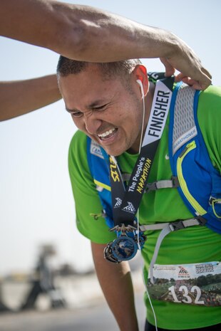 A participant receives a medal after completing the Marine Corps Marathon Forward, Oct. 30, 2016. MCM Forward gives runners in forward-operating locations around the globe the opportunity to run the "People's Marathon." (U.S. Marine Corps Photo by Sgt. Donald Holbert)