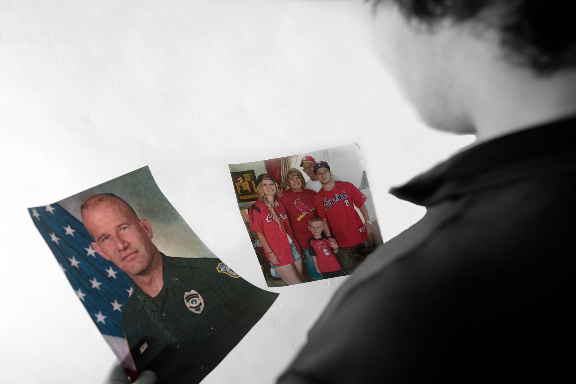 Zach Donnelly, son of the late Dave Donnelly, holds photos of his father and his family at Ellsworth Air Force Base, S.D., Nov. 4, 2016. Donnelly’s father passed away on Oct. 15 after a long battle with cancer. Prior to becoming a police officer with the Department of the Air Force, Dave served 10 years in the U.S. Army. (U.S. Air Force photo illustration by Airman 1st Class Denise M. Jenson)
