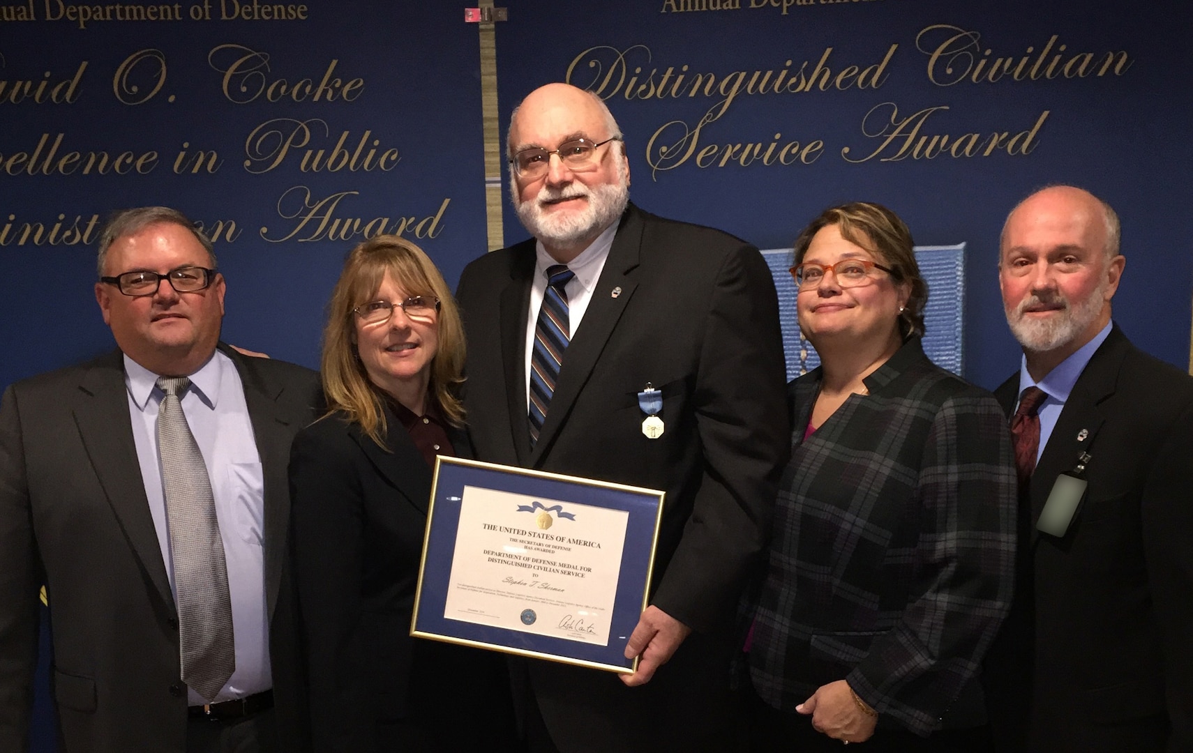 Stephen Sherman (center), director of Document Services in DLA Information Operations, received the Distinguished Civilian Service Award Nov. 3 at the Pentagon, in recognition of achievements over his 37-year career with DoD. 