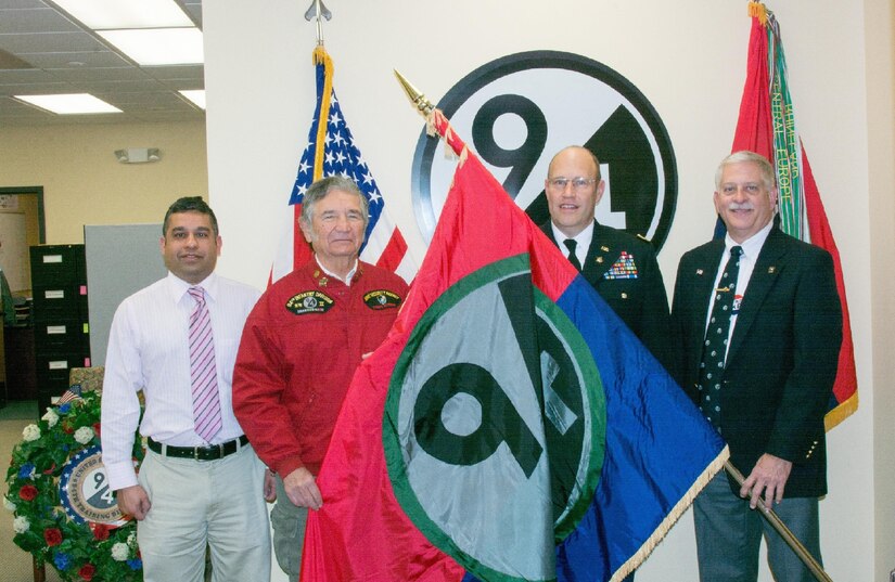 (Left to right) 94th Training Division Chief Executive Officer Vivek Kshetrapal, 94th Infantry Division Historical Society Secretary John Clyburn, 94th Training Division Assistant Division Commander Col. John Aarsen, and 94th IDHS Immediate Past President Bill Van Sant participate in the flag transfer held at Fort Lee, Virginia, Nov. 21, 2016. The 94th IDHS passed their World War II colors to the current 94th Training Division at the division's headquarters.