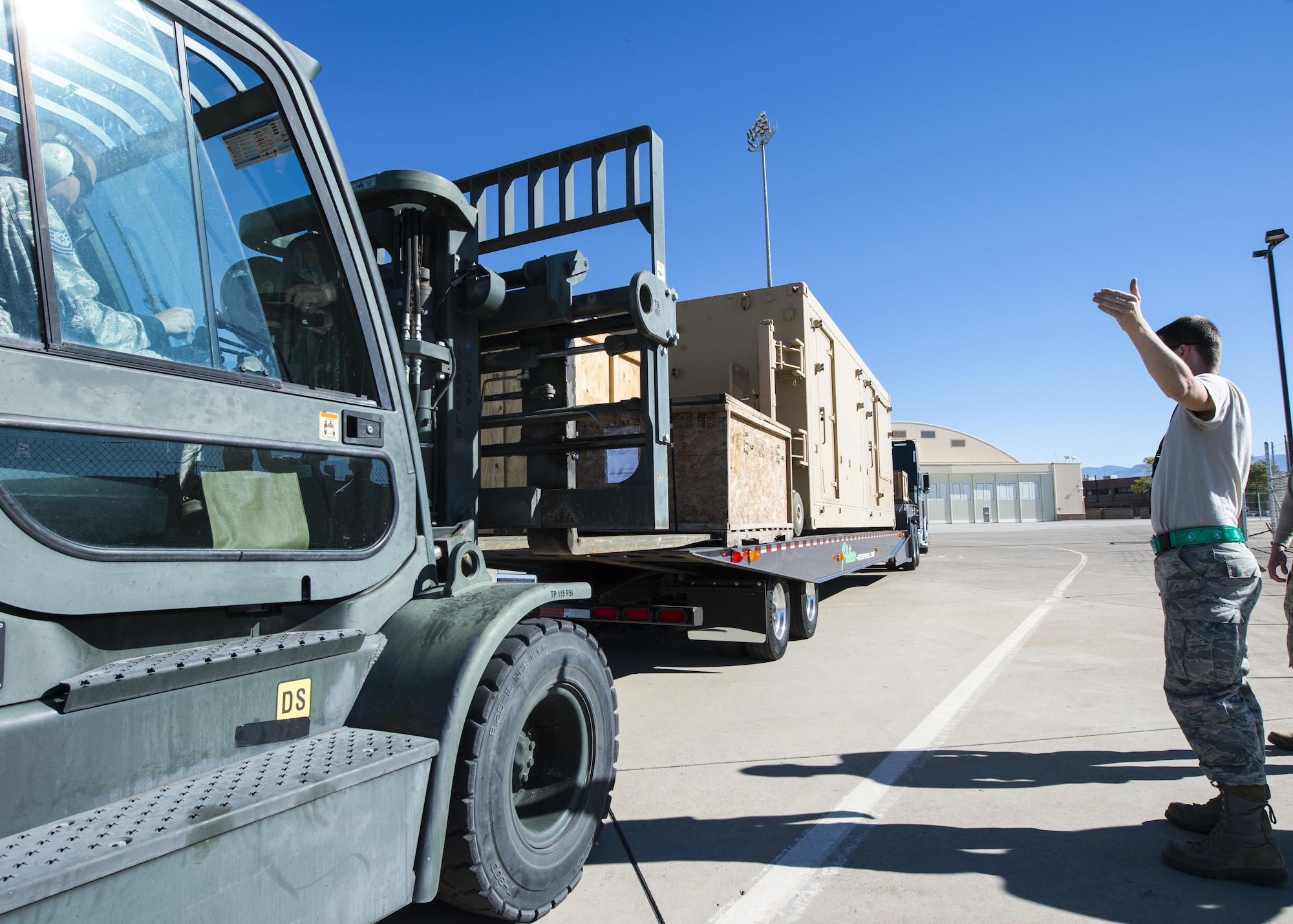 Staff Sgt. Paul, a 49th Aircraft Maintenance Squadron aircraft communications maintenance technician, guides a forklift to unload a new Ground Control Station from a delivery truck Nov. 14 at Holloman Air Force Base, N.M. All GCSs at Holloman are scheduled to be replaced by early 2018 as part of an Air Force-wide initiative to upgrade current Remotely Piloted Aircraft mission systems. (U.S. Air Force photo by Senior Airman Emily Kenney)