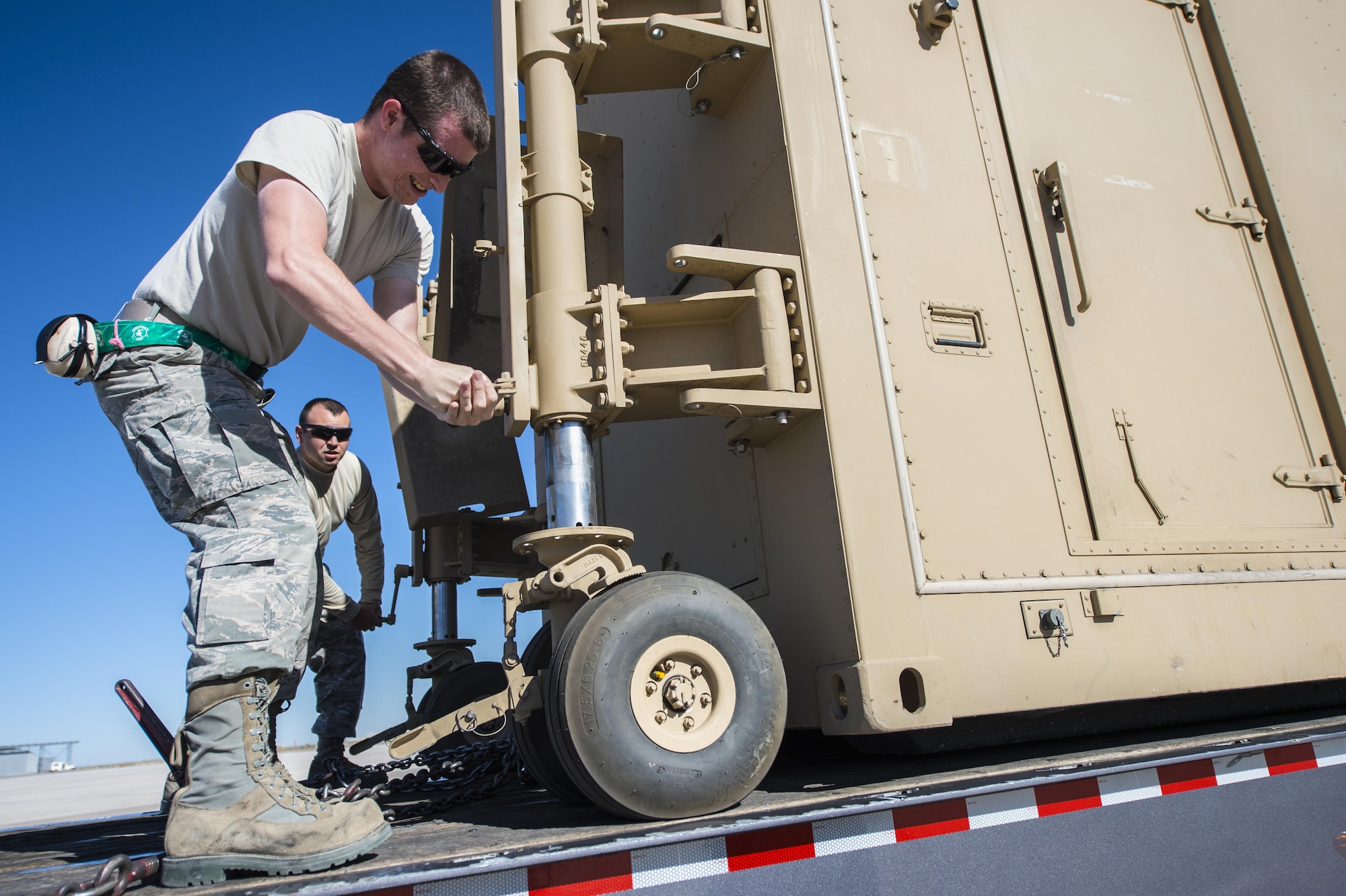 Staff Sgt. Paul, a 49th Aircraft Maintenance Squadron aircraft communications maintenance technician, prepares a new Ground Control Station to be unloaded Nov. 14 at Holloman Air Force Base, N.M. The upgraded systems are designed to be more user-friendly and increase Remotely Piloted Aircraft training and mission capabilities. (U.S. Air Force photo by Senior Airman Emily Kenney)