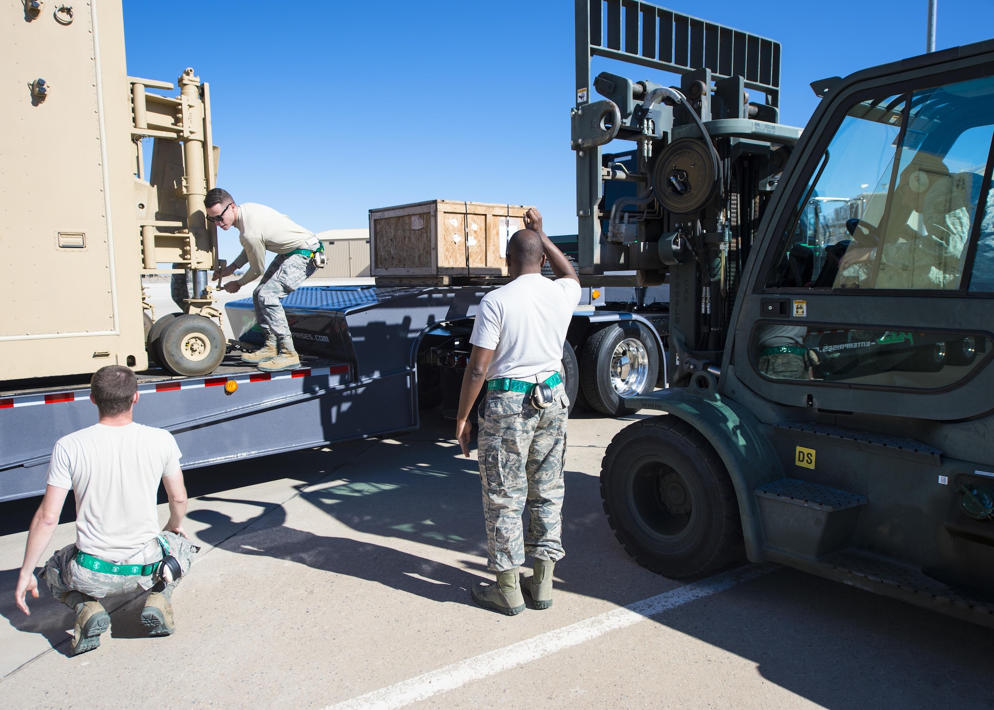 Aircraft communications maintenance technicians from the 49th Aircraft Maintenance Squadron here unload a new Ground Control Station from a delivery truck Nov. 14 at Holloman Air Force Base, N.M. The delivery was the first of 15 new GCSs to be delivered as part of an Air Force-wide initiative to replace current Remotely Piloted Aircraft mission systems. (U.S. Air Force photo by Senior Airman Emily Kenney)