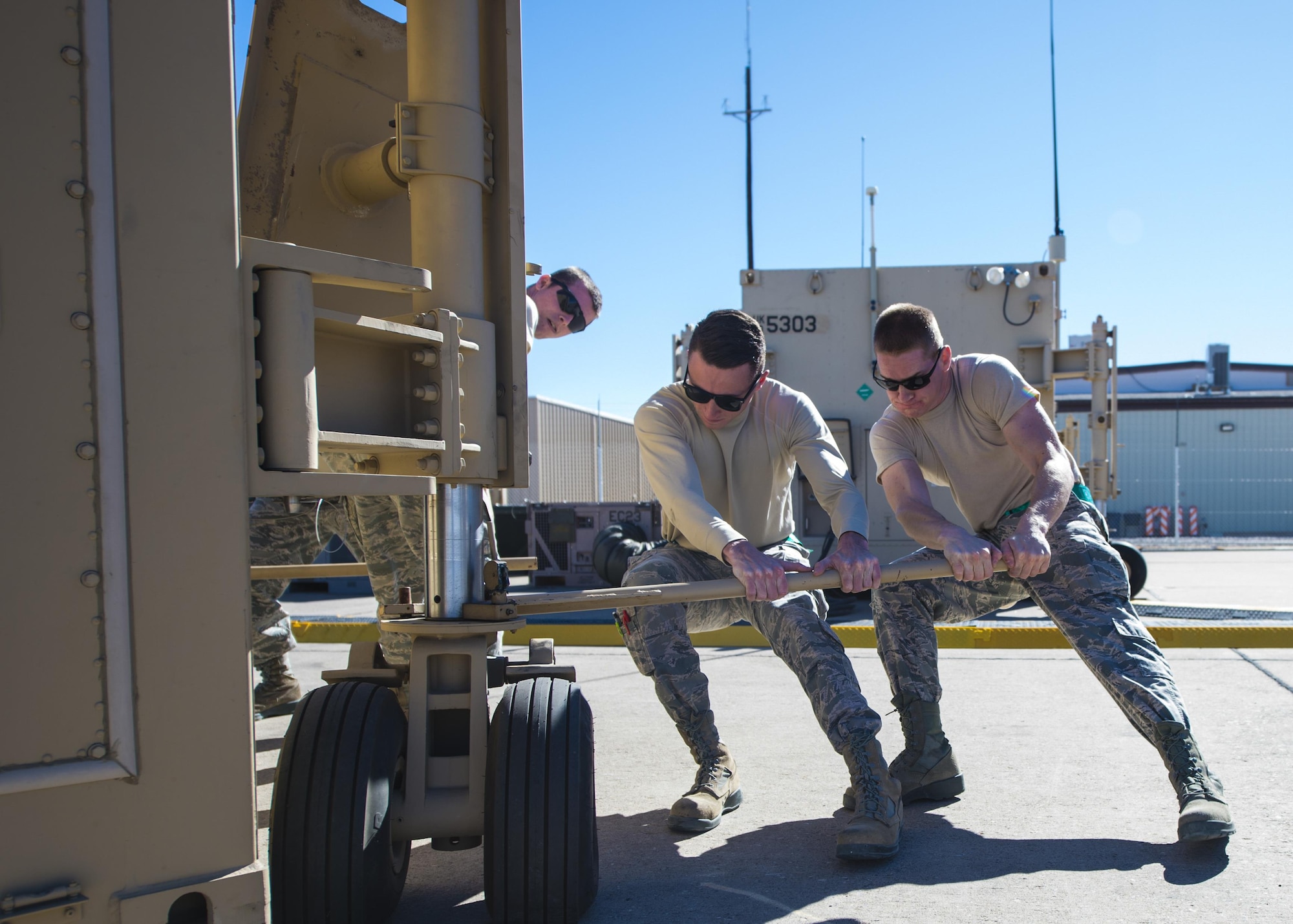 Senior Airman Tyler (left) and Airman 1st Class Bryton (right), 49th Aircraft Maintenance Squadron aircraft communications maintenance technicians adjust a Ground Control Station into its proper place Nov. 14 at Holloman Air Force Base, N.M. The delivery of the first new GCS is part of an Air-Force wide initiative to upgrade current systems to be more user-friendly and increase Remotely Piloted Aircraft mission capabilities. (U.S. Air Force photo by Senior Airman Emily Kenney) 