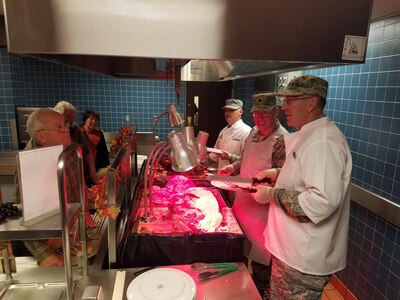 Gen. John E. Hyten (right), U.S. Strategic Command (USSTRATCOM) commander; Chief Master Sgt. Patrick F. McMahon (third from right), USSTRATCOM senior enlisted leader; and other leaders from Offutt Air Force Base, Neb., serve Thanksgiving meals to military members, veterans and families at the King Dining Facility, Nov. 24, 2016. Hyten assumed command of USSTRATCOM on Nov. 3.