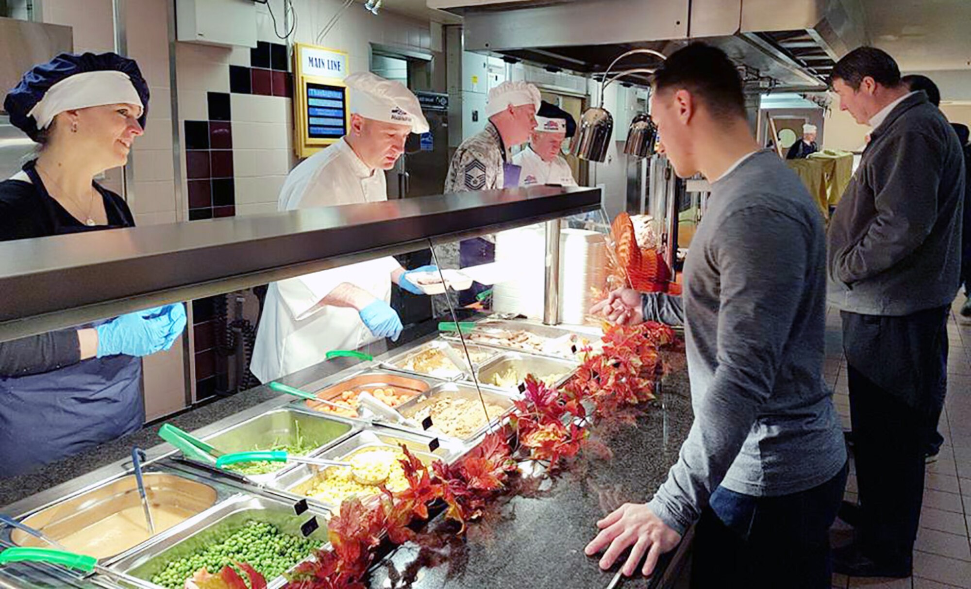 Team Mildenhall leadership serve Thanksgiving lunch Nov. 24, 2016, at the Gateway Dining Facility on RAF Mildenhall, England. Team Mildenhall leadership and their spouses joined with the dining facility staff to provide Airmen the opportunity to enjoy Thanksgiving away from home. (U.S. Air Force photo by Karen Abeyasekere) 