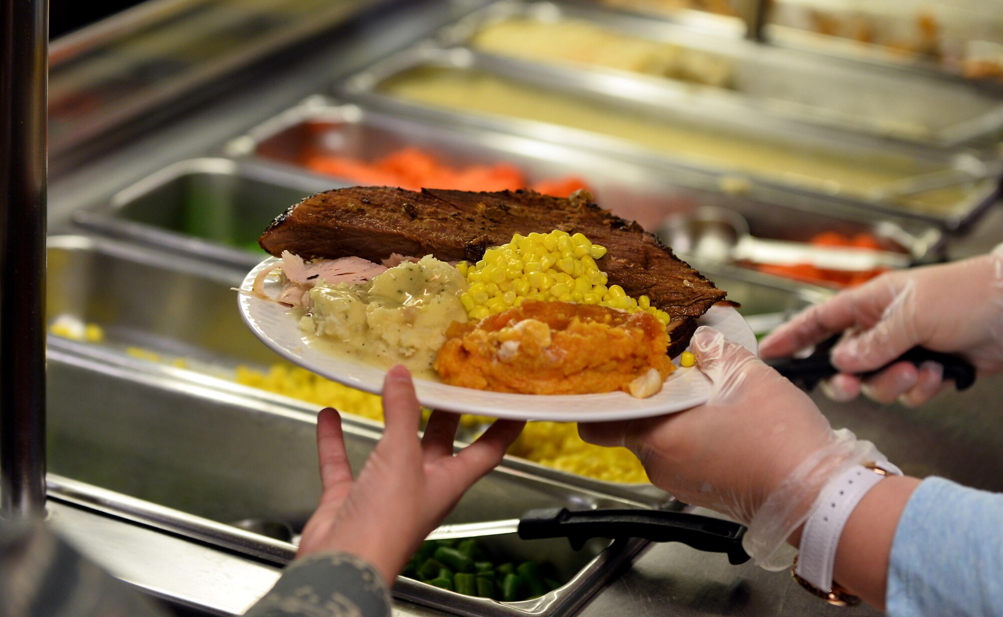 The food service professionals of the 55th Force Support Squadron spent more than 14 hours preparing Thanksgiving dinner for their fellow Airmen. Meals were also prepared for delivery to the Airmen who were working around the base on the holiday. (U.S. Air Force photo by Josh Plueger)