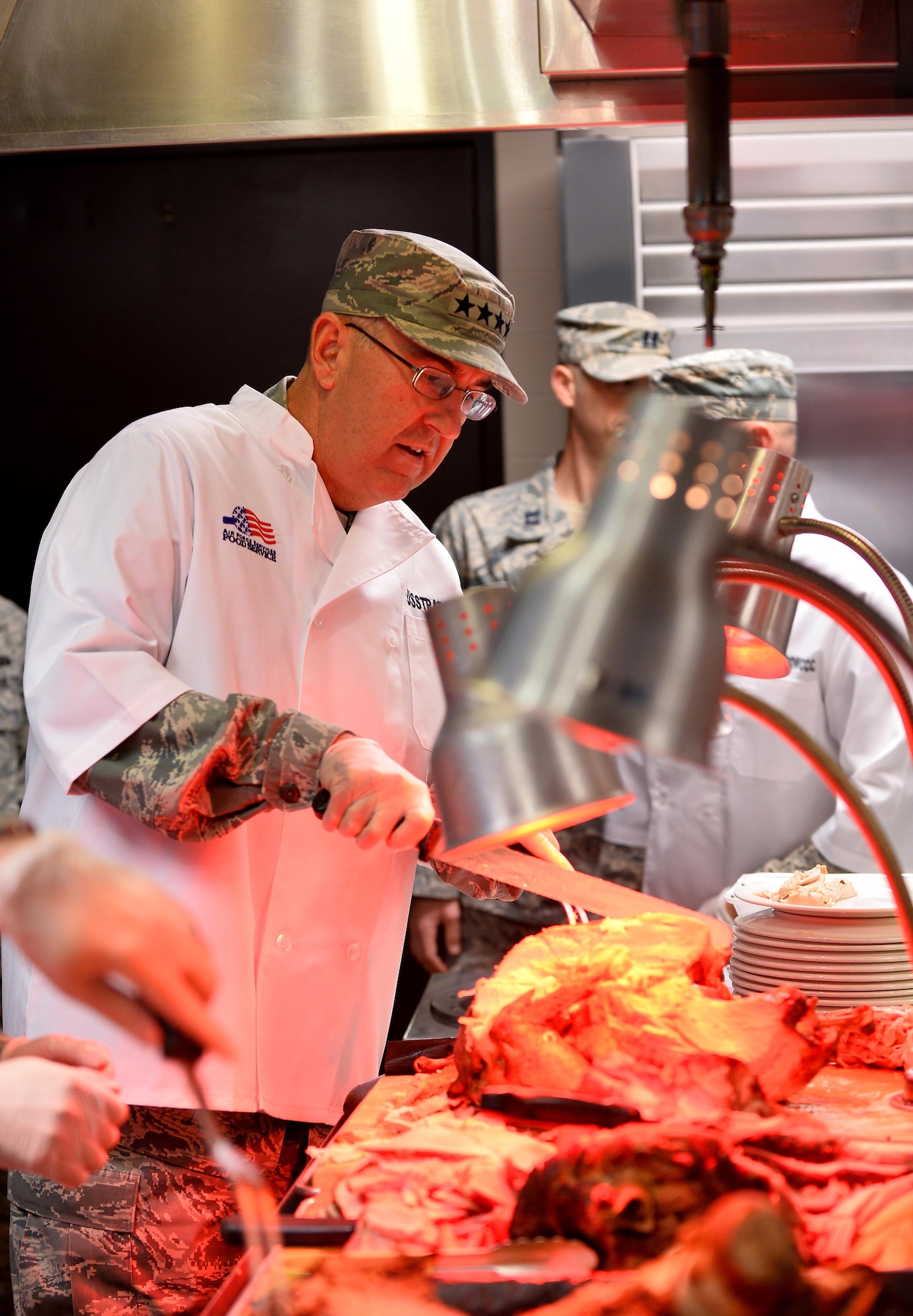 Gen. John E. Hyten, Commander of U.S. Strategic Command, spends the afternoon cutting and serving meat to Airmen, veterans and their families on Thanksgiving afternoon at the Ronald L. King Dining Facility Nov. 24, Offutt Air Force Base, Neb.  It’s an annual tradition for wing leadership to serve Airmen Thanksgiving dinner at the dining facility as a way to say thanks.  (U.S. Air Force photo by Josh Plueger)