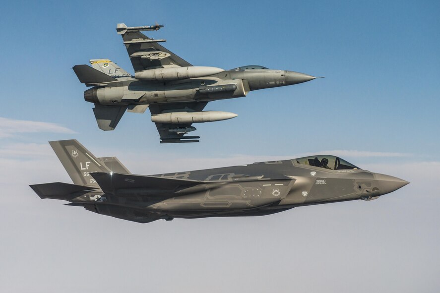 An F-35A Lightning II flies alongside an F-16 Fighting Falcon June 25, 2015, at Luke Air Force Base, Ariz. In October, F-35 and F-16 pilots began integrated training designed to improve mission cooperation and flight skills in both airframes. (Courtesy Photo)