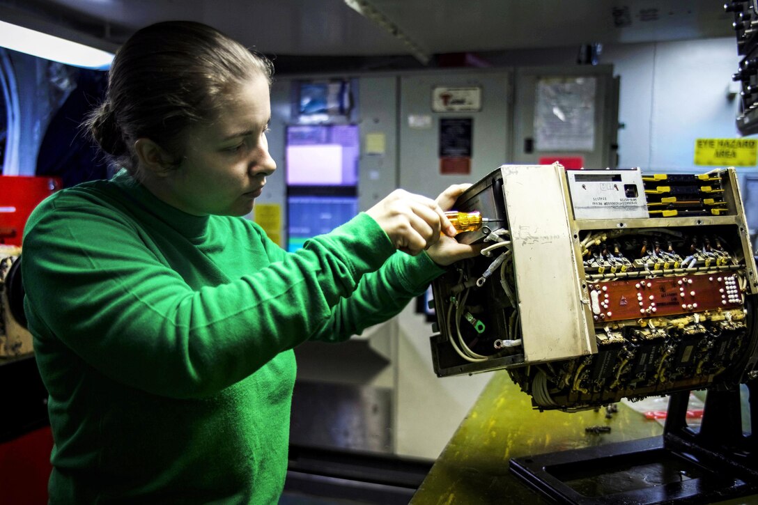 Navy Petty Officer 3rd Class Sasha Holcomb conducts maintenance on a generator in the avionics shop on the aircraft carrier USS Dwight D. Eisenhower in the Persian Gulf, Nov. 24, 2016. Holcomb is an aviation electrician's mate. Navy photo by Seaman Christopher A. Michaels
