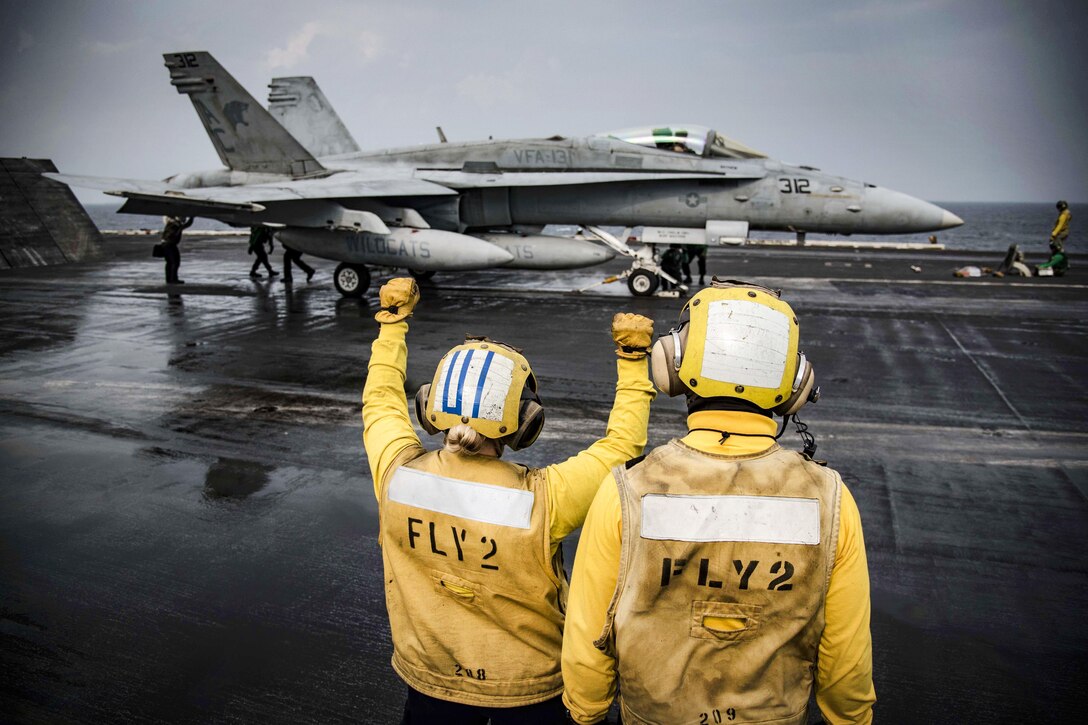 Sailors signal an F/A-18C Hornet to prepare to launch from the flight deck of the aircraft carrier USS Dwight D. Eisenhower in the Persian Gulf, Nov. 24, 2016. Navy photo by Petty Officer 3rd Class Anderson Branch